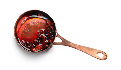 Saucepan with red mulled wine on white background, top view