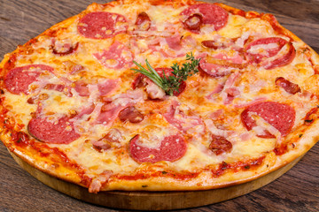 Pizza with ham and sausages