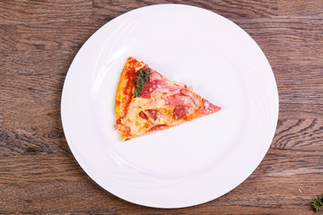 Pizza with ham and sausages