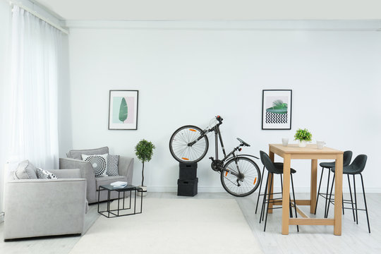 New bicycle near wall in stylish room interior