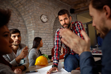 modern architects discussing ideas and planning for project.