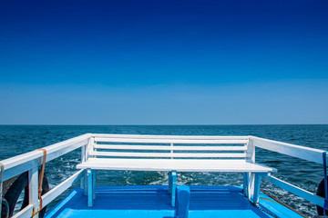 Fototapeta na wymiar Stern seating to enjoy the view of the sea under blue sky.