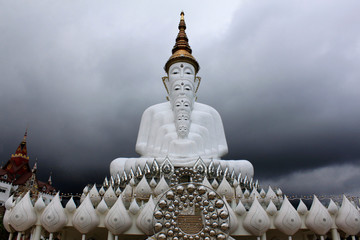 Front view of five sitting white Buddhas and a cloudy sky at Pha Sorn Kaew, in Khao Kor, Phetchabun, Thailand