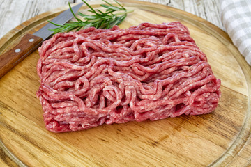 raw minced meat on wooden board