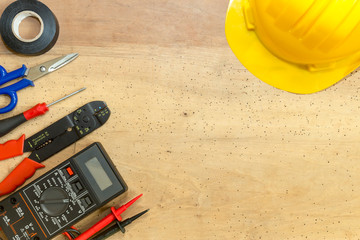 Electrician tools, components and instruments  on a wooden background