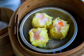 Dumplings made of flour placed in a wooden tray on the table.