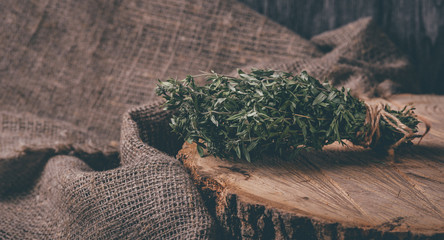 Food background of herb thyme on black kitchen table from above.