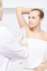 Fototapeta na wymiar Unwanted hair wax epilation. Young Woman. cosmetology salon treatment procedure. Home waxing