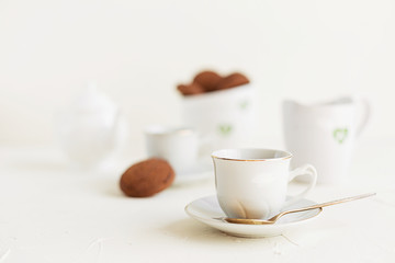 Breakfast on white table, tea and biscuits
