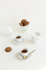 Breakfast on white table, tea and biscuits