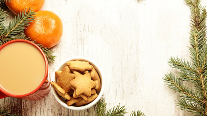 Fototapeta na wymiar NewYear. Cup of coffee. Delicious tangerines. Spruce branch. Gingerbread Cookie