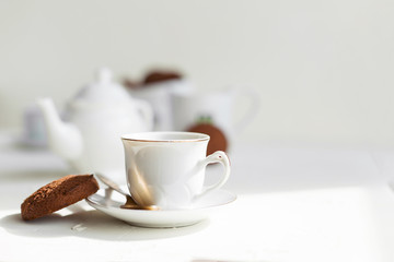 Breakfast on white table, tea and biscuits