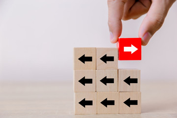 Hand picked red wooden blocks with white arrows facing opposite to the black arrows. With different...