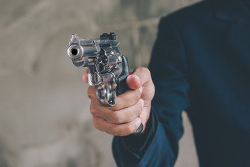 Businessman holding a gun to kill himself committed suicide because of despondent and despair in the office.