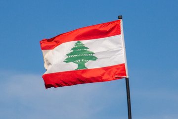 Fototapeta na wymiar The Lebanese flag of Lebanon flies in the sun, in Beirut, Lebanon