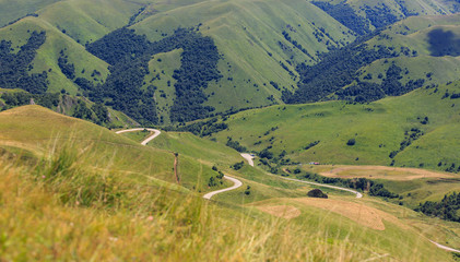 Top view of the hills and meadows overgrown with grass. Photographed in the Caucasus, Russia.