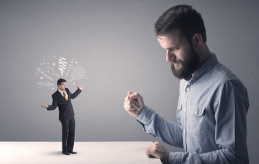 Young professional businessman being angry with an other miniature businessman who has scribbles above his head