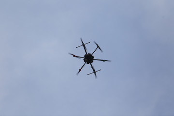 Fototapeta na wymiar A big drone hovers above ground