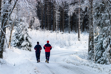 Couple running on a forest road