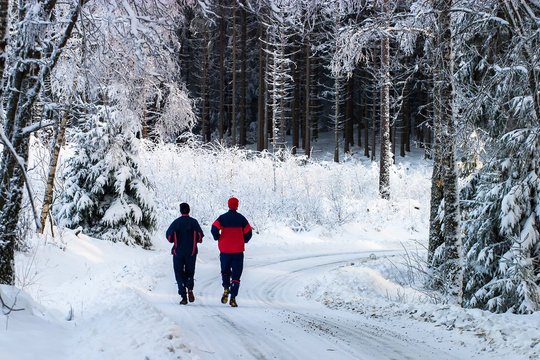 Couple running on a forest road