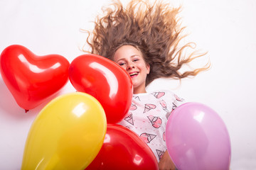 girl with balloons, child with balloons, child with balloons lying on white background