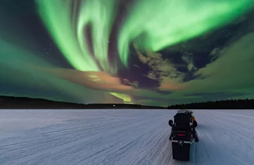 Fotobehang Aurora hunting with snowmobile © Tim