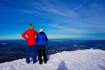 Couple stand on snow mountain of salzburg with landscape view under blue sky
