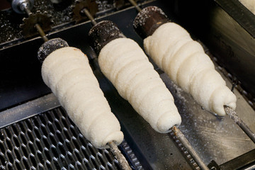 Trdelnik is famous dessert in Prague. Hot bread binding on top with sugar.