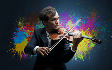 Young classical violinist musician with colorful splotch wallpaper
