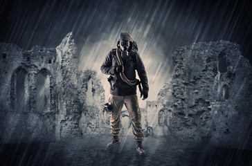 Hazard, menace man in a ruined crumbly building with arms on his hand
