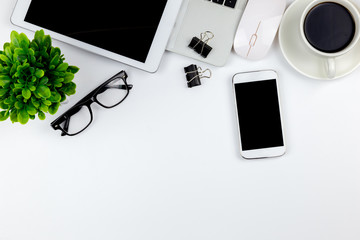 Workspace in office with tablet and smartphone with empty blank screens are on top,Top view with copy space.