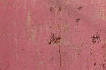 Weathered rough pink painted metal wall texture
