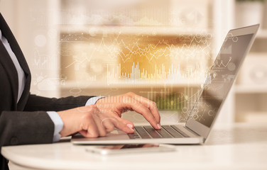 Business woman in homey environment using laptop with global financial report concept

