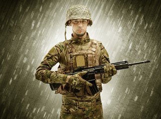 Armed soldier standing in rainy weather
