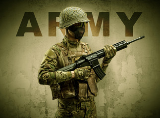Uniformed armed soldier with damaged wall background
