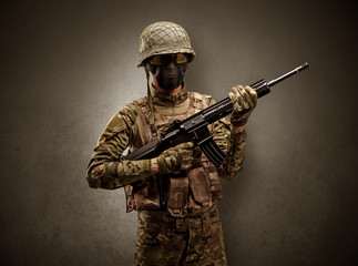Soldier agent in a dark room with arms on his hand and gas mask
