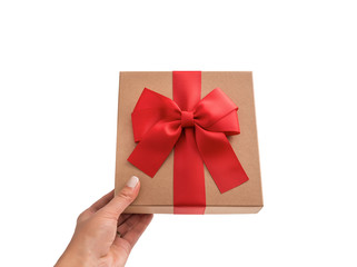 Gift box in female hand on white background.