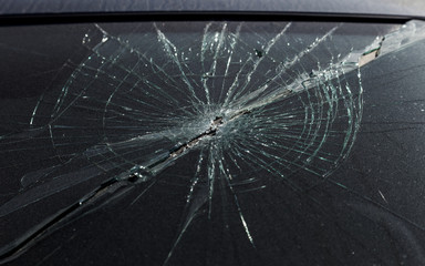 Terrible dangerous car after a fatal accident. Broken windshield. A broken car with broken glass....