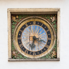Fototapeta na wymiar Tallinn, vintage sundial on the wall of the Saint Esprit church, in the old town 