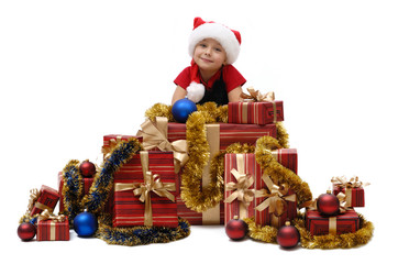 Cute little girl in a Santa Claus cap with Christmas gifts, isolated