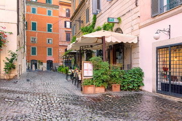 Old cozy street in Rome at morning, Rome, Italy. Architecture and landmark of Rome. 
