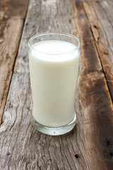 Glass of milk on wooden table. Food and drink background.