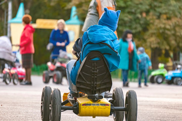 little kid driving the mini toy car in the street  f