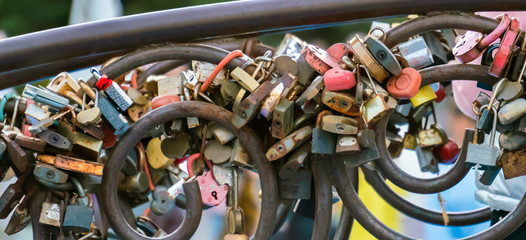 many wedding love locks on the railing in the street outdoor