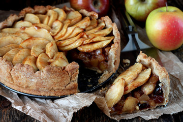 Baked apple with nuts, cinnamon sticks and cranberry 