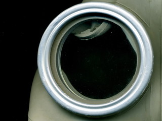 Old Soviet green gas mask. The eye of an old gas mask. postapocalypse.