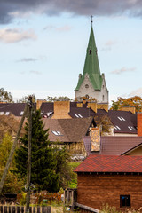 .63/5000.Dobele, Latvia. View of the church tower and private house roofs.