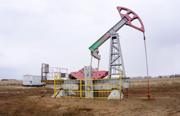 Oil pumps operate against a cloudy sky