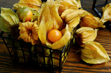 Close up Cape gooseberries or Physalis on wooden background with shadow.