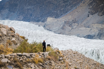 A man walking along the track to see Passu glacier in Karakoram mountain range. Gojal Hunza. Gilgit...